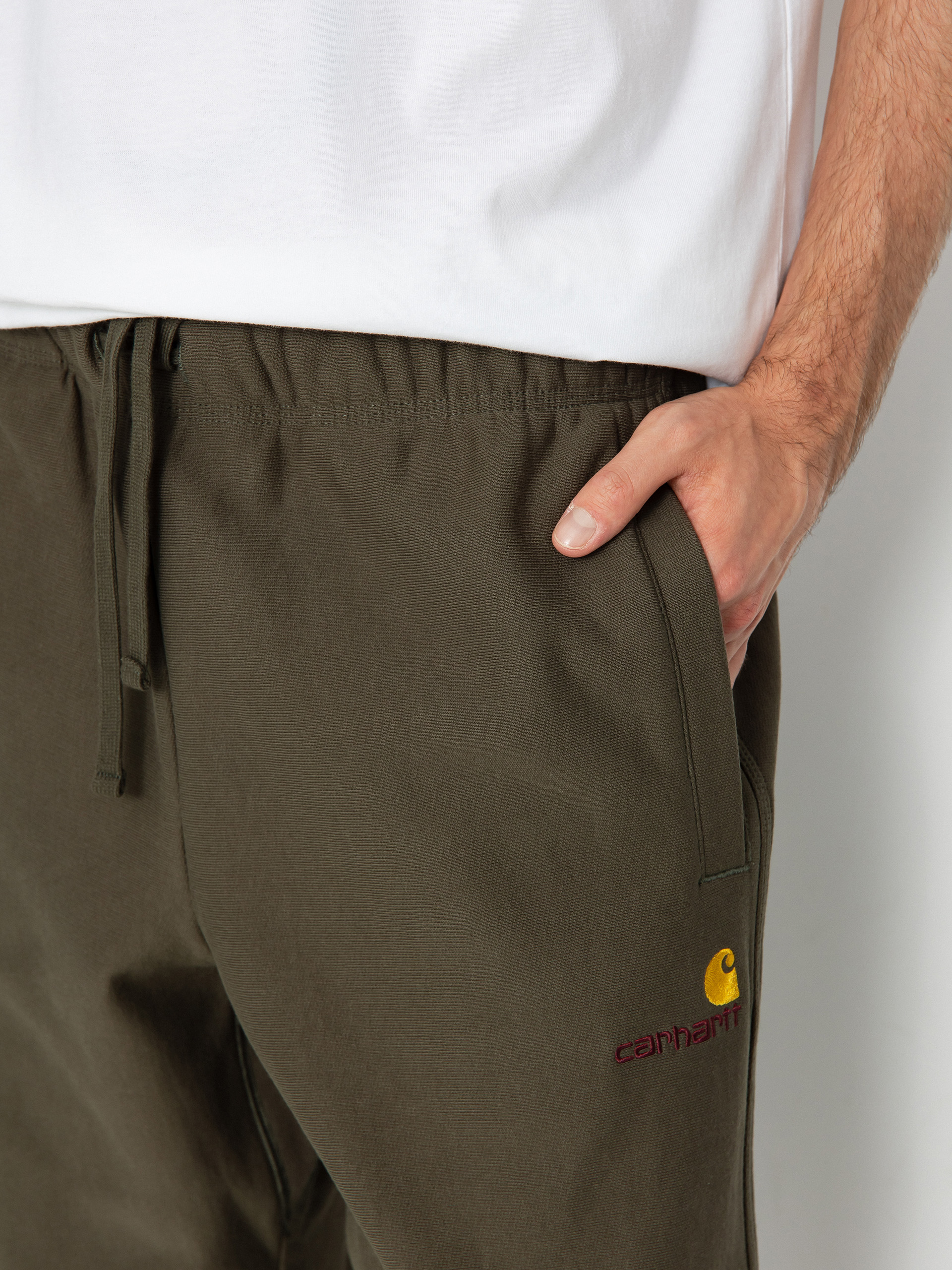 Kalhoty Carhartt WIP American Script Jogging (plant)