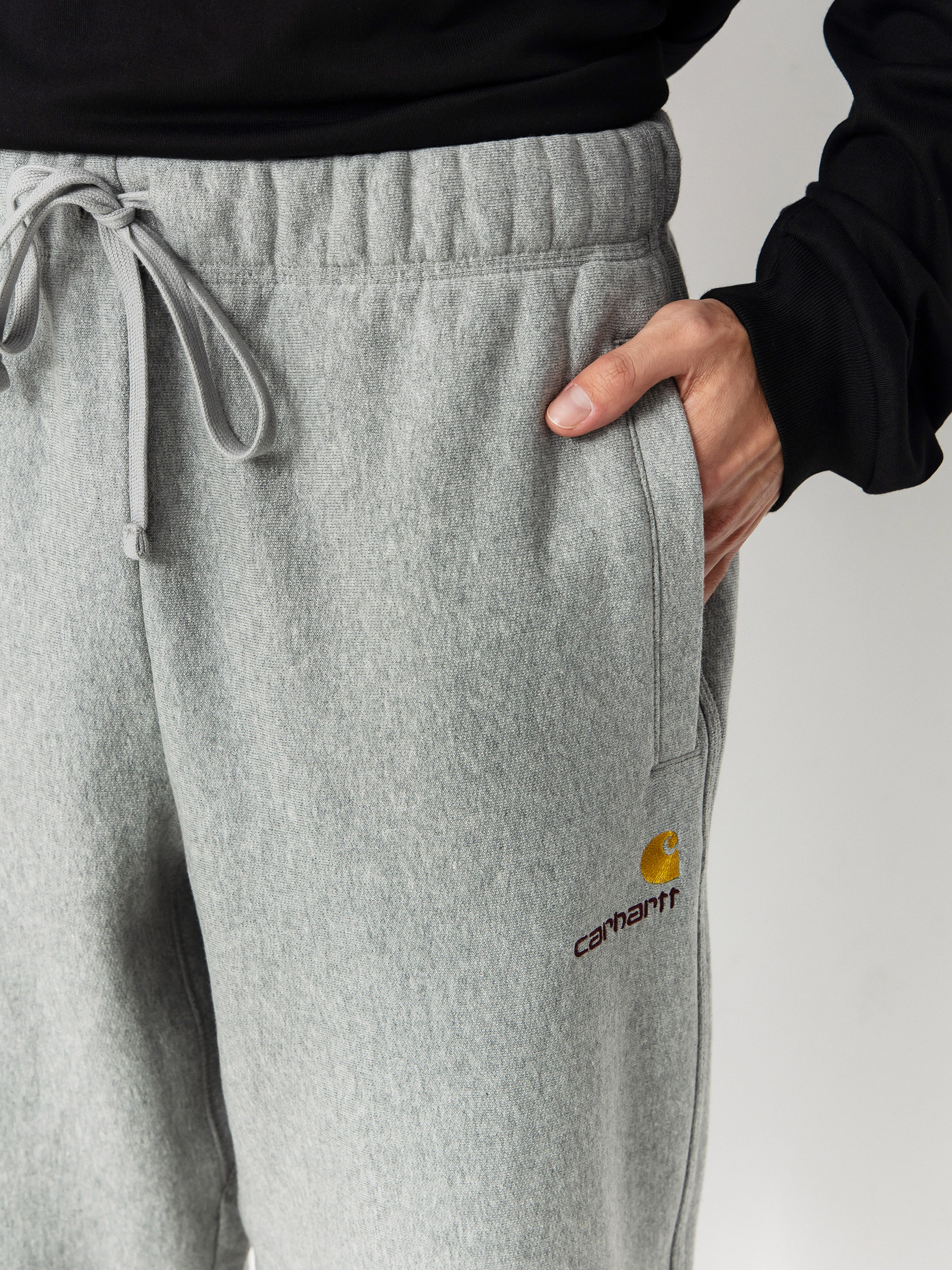 Kalhoty Carhartt WIP American Script Jogging (grey heather)