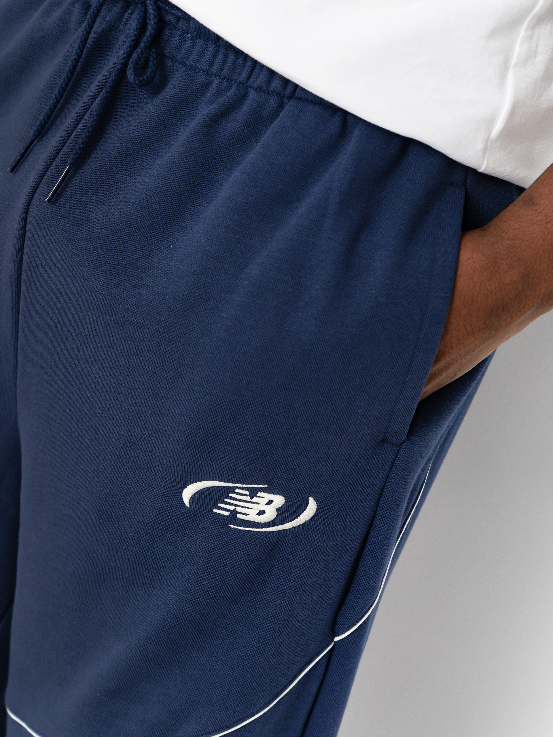 Kalhoty New Balance Trackside French Terry (navy)